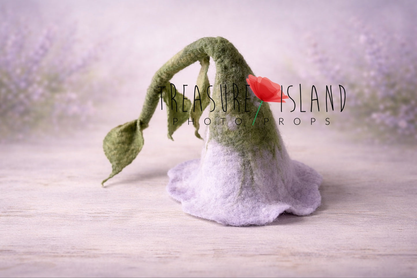 Hand-felted flower bonnet for newborn photography in lavender and green tones, made from natural wool, styled on a soft pastel background. Treasure Island Photo Props.