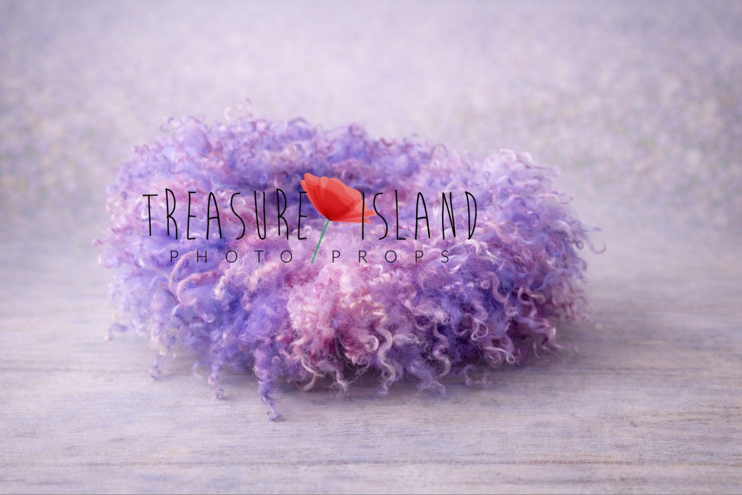 Hand-felted newborn photography curly blanket in soft and lavender, blush pink and delicate purple color, made from natural curly sheep wool, styled on a delicate pastel backdrop. Treasure Island Photo Props.