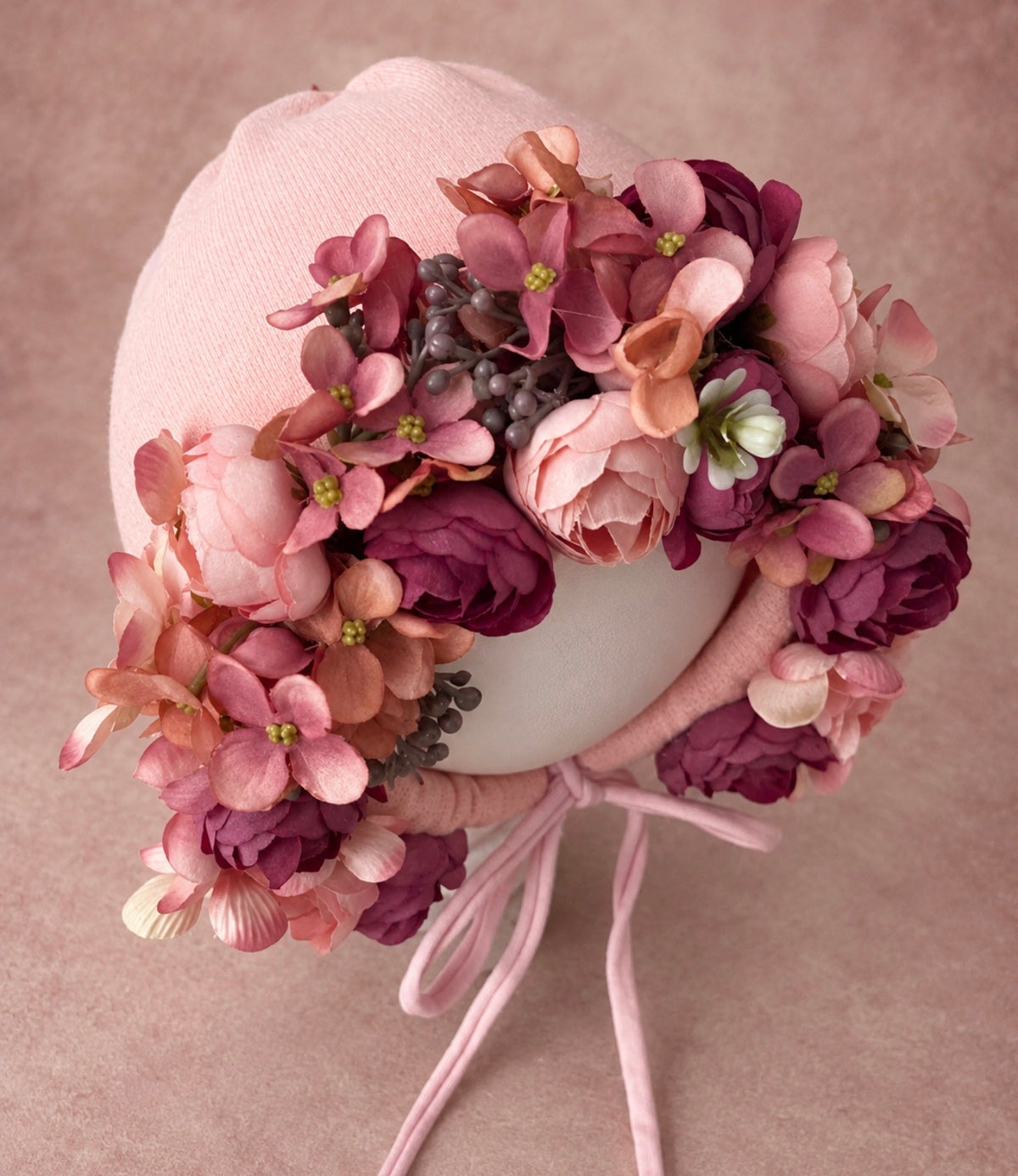 Side view of berry and mauve floral photography bonnet showing layered flowers and soft pink bonnet base