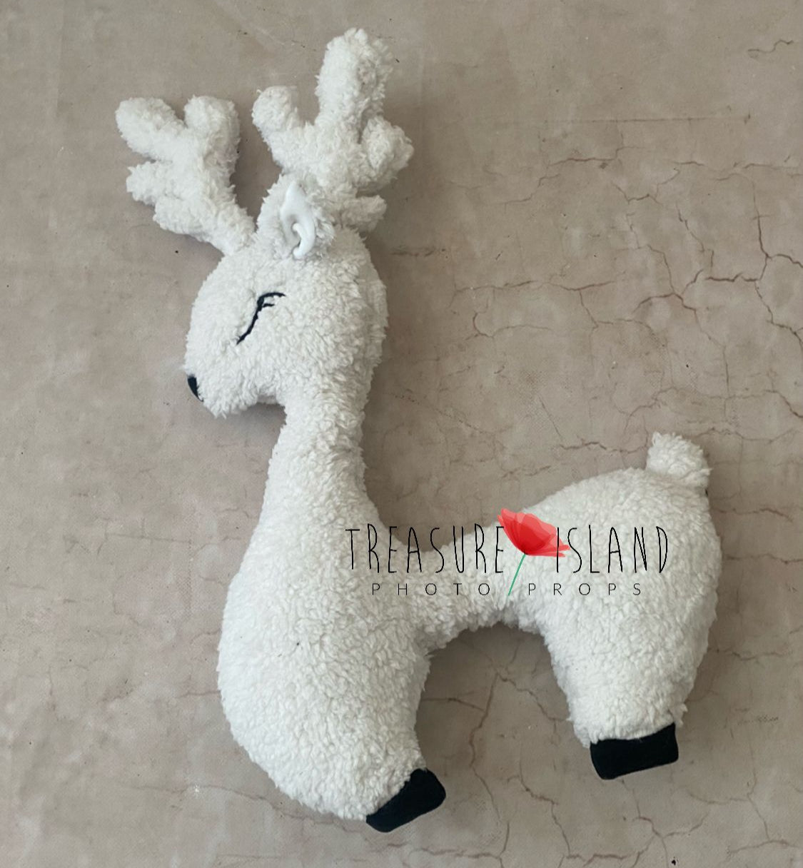 Cream white reindeer newborn posing pillow with embroidered details and soft antlers on light backdrop