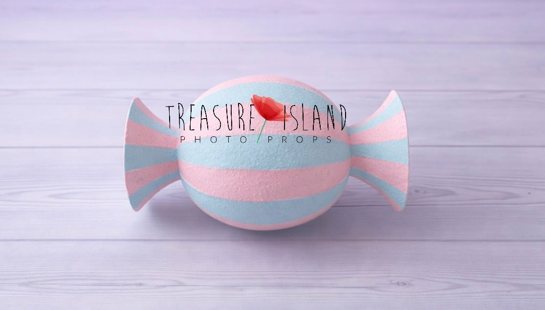 Pastel pink and blue faux candy prop for cake smash photography, hand-painted striped design on studio background