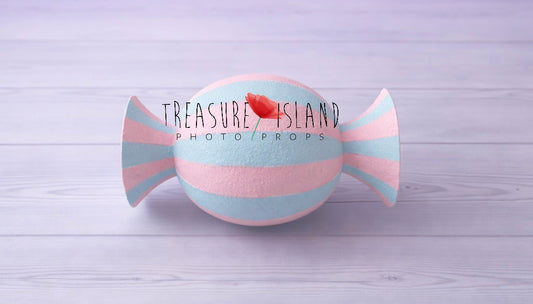 Pastel pink and blue faux candy prop for cake smash photography, hand-painted striped design on studio background