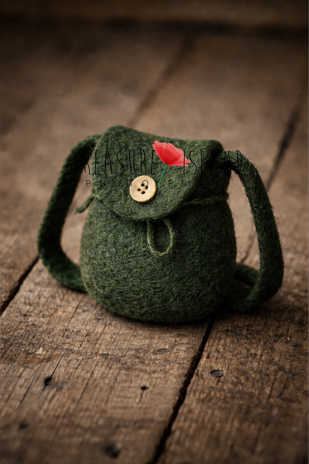 Luxury forest green needle-felted miniature backpack, premium newborn photography prop styled on aged rustic wood