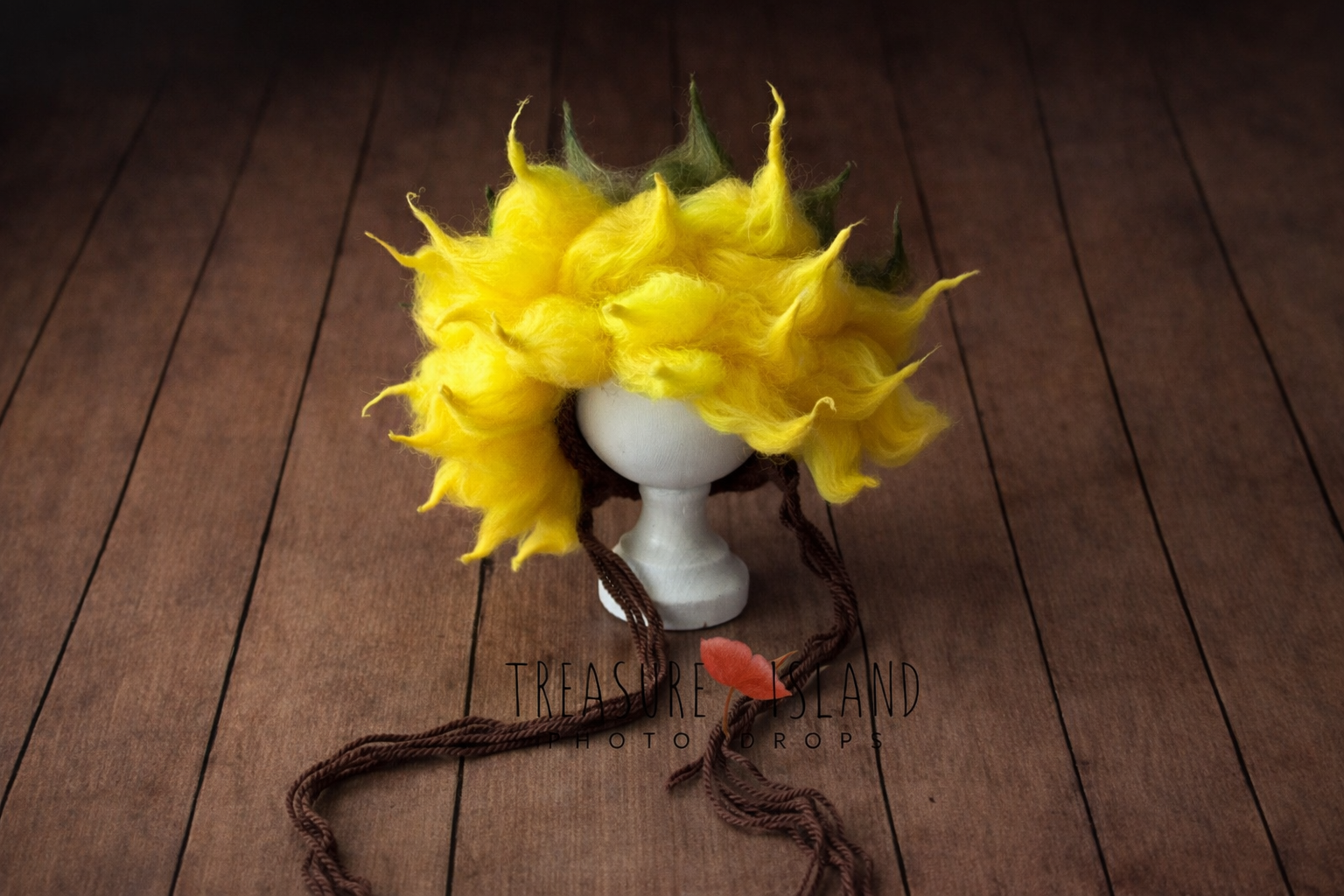 Luxury sunflower newborn photography bonnet  ,soft yellow wool petals on rustic wooden background
