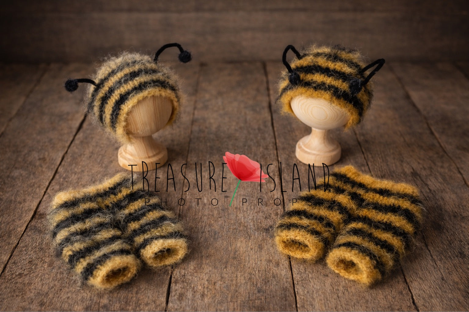 Handmade bumblebee newborn photography prop set with fuzzy striped bonnet and matching shorts displayed on a rustic wooden floor.
