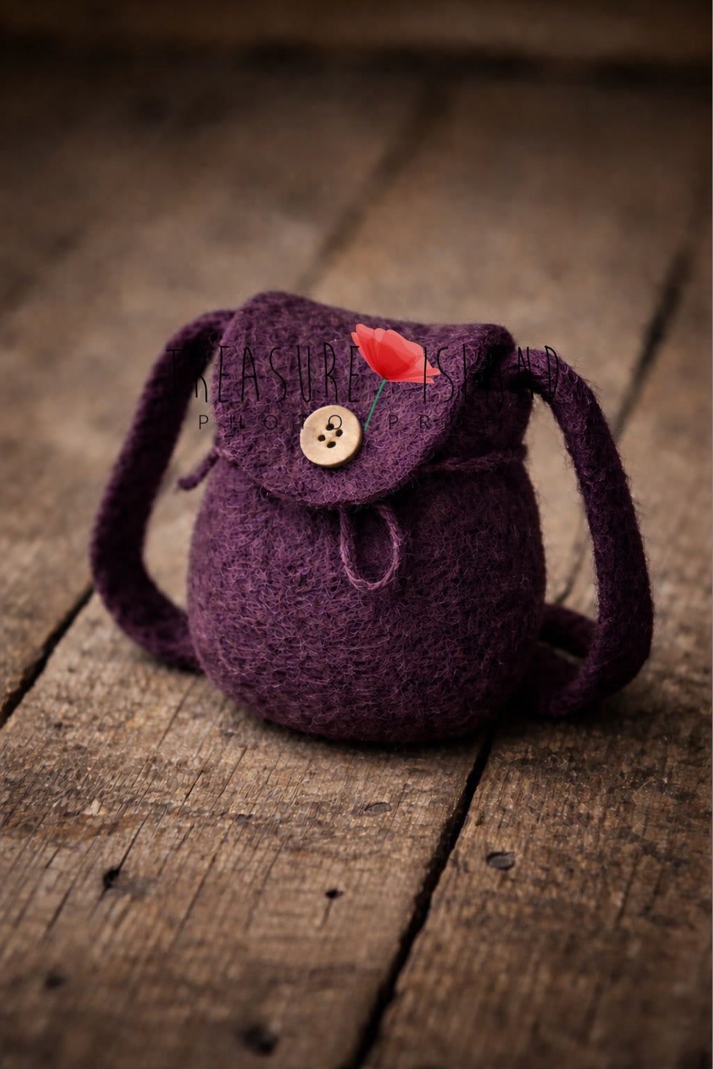 Luxury deep eggplant purple handmade felt backpack, miniature newborn photography prop displayed on vintage wooden floor