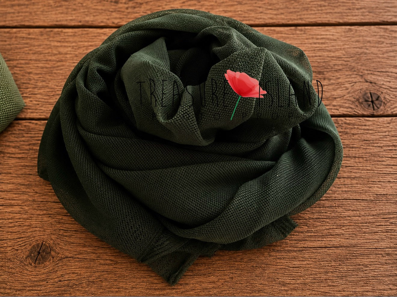 Dark pine green newborn photography wrap with soft mesh texture styled on rustic wooden floor – extra stretch posing fabric for newborn photo sessions