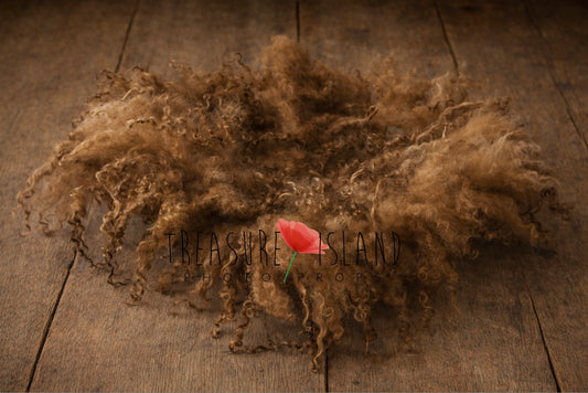 Hand-felted newborn photography blanket in rich hazelnut brown tone, natural curly sheep wool styled on old wooden floor background