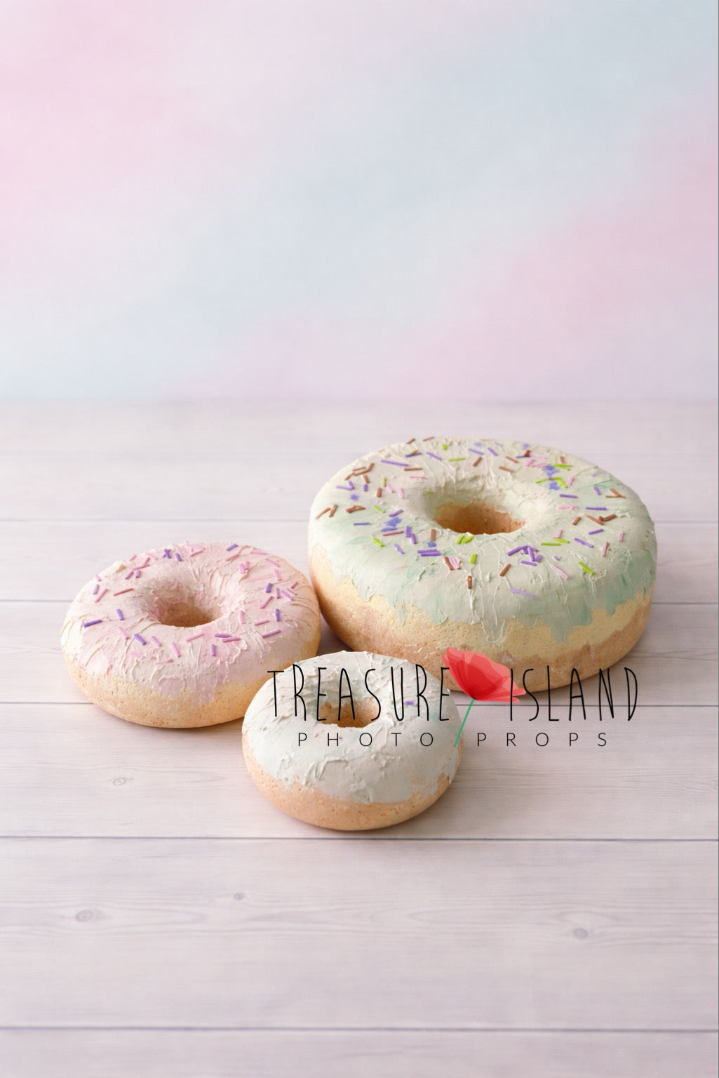 Oversized faux doughnut prop set for cake smash photography, hand-painted pastel icing with colorful sprinkles on studio background

