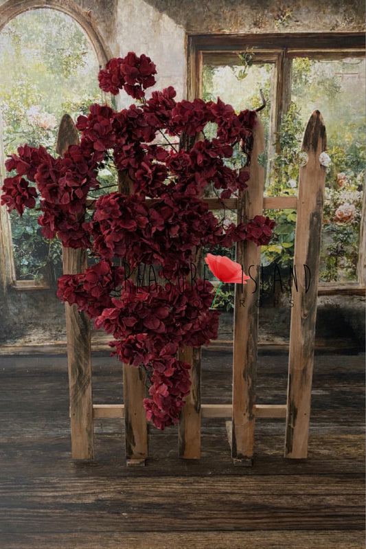 Wine hydrangea garland draped over rustic wooden fence – newborn photography backdrop prop