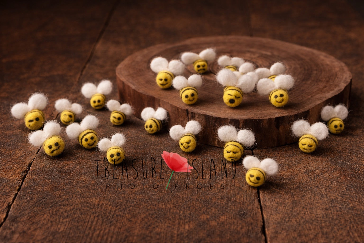 tiny handmade mini felt bees for newborn photography prop styled on rustic wooden floor with natural wood slice
