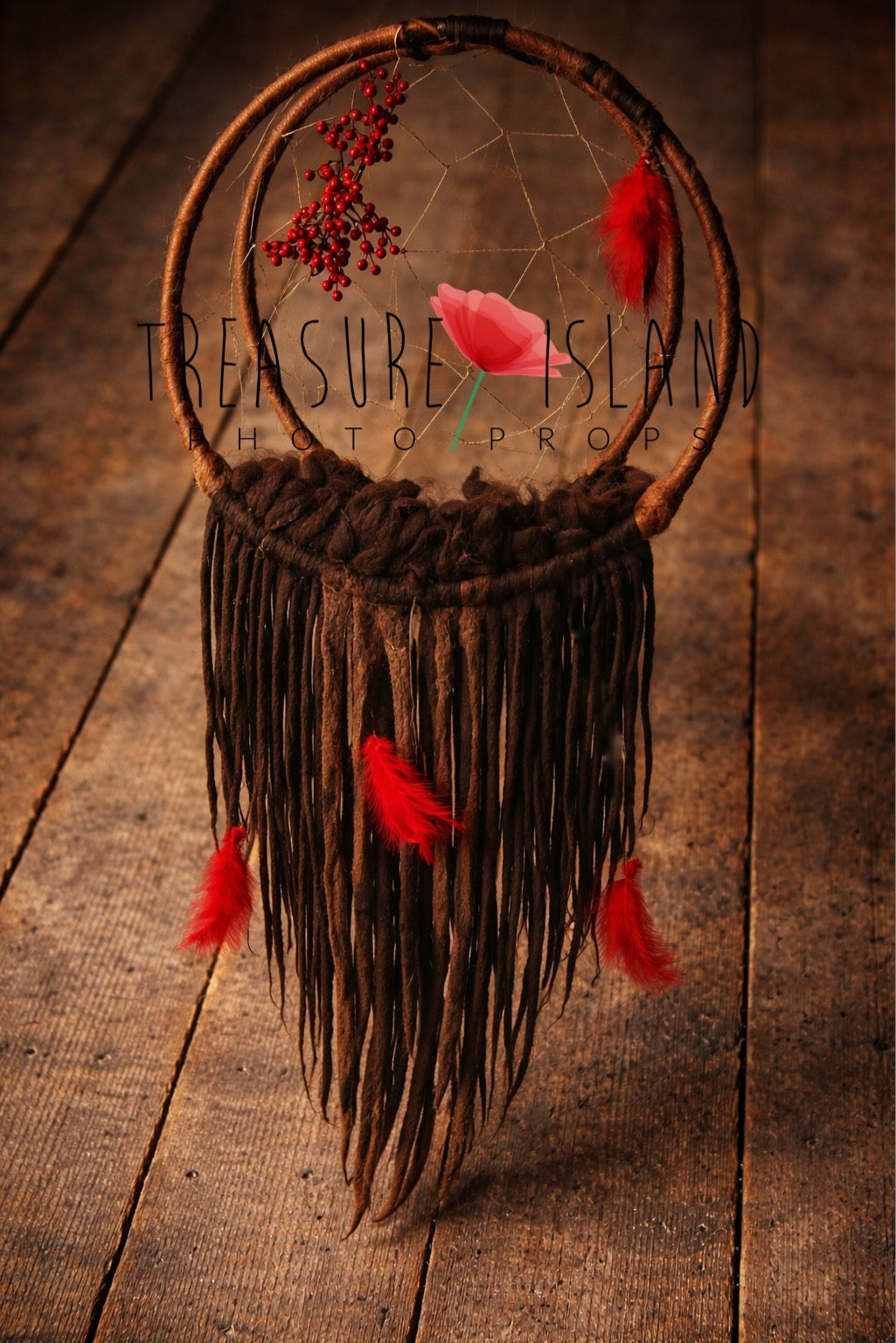 Boho hanging dream catcher photography prop with felted dreadlocks, red feathers and rowan berries on rustic wooden background.