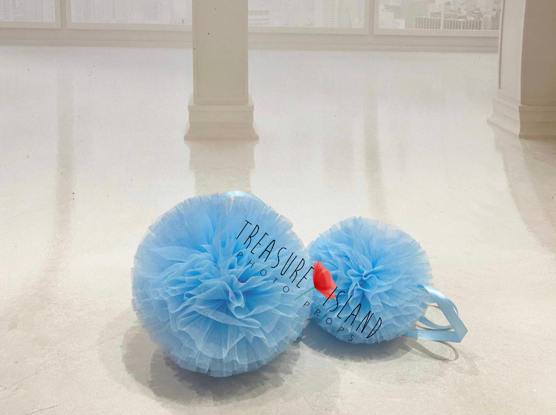 Blue tulle pom poms in multiple sizes for photography setups