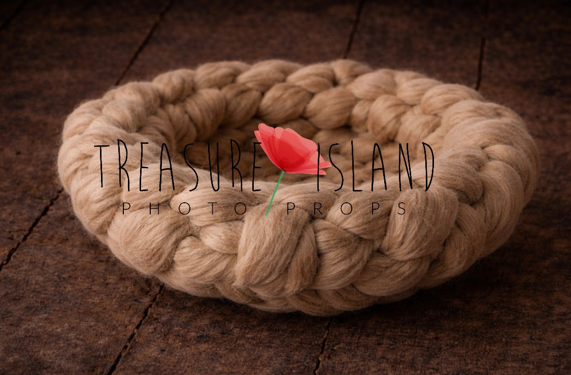 Close-up of chunky wool newborn photography nest inPorcelain showing thick knitted texture