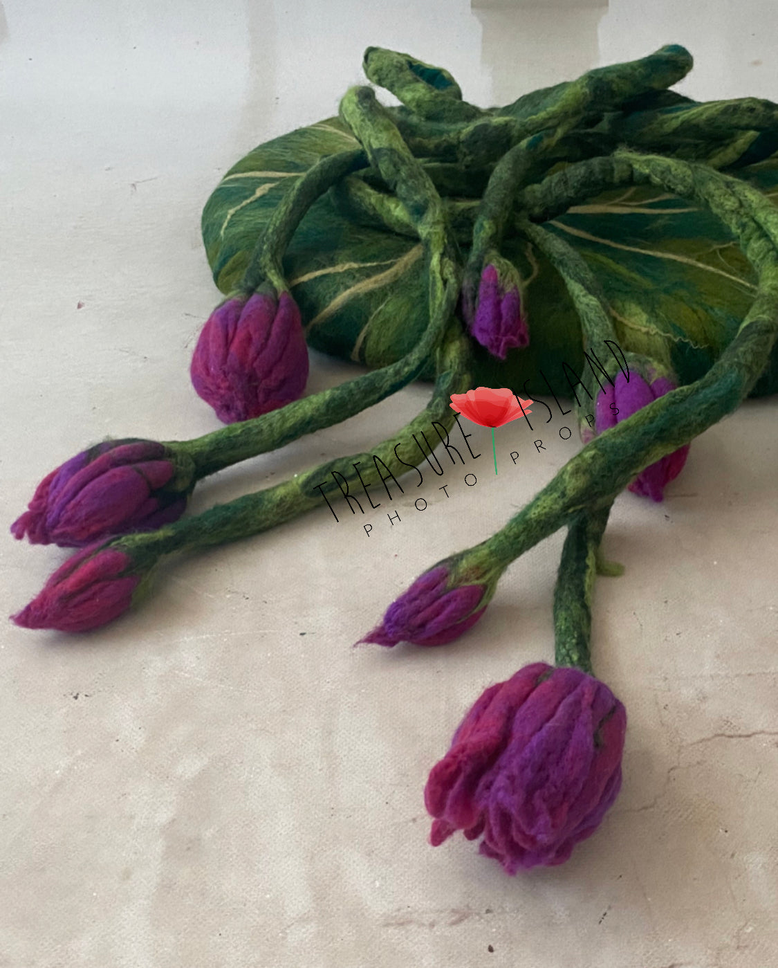 Close-up of felted botanical vine handcrafted for newborn photography styling