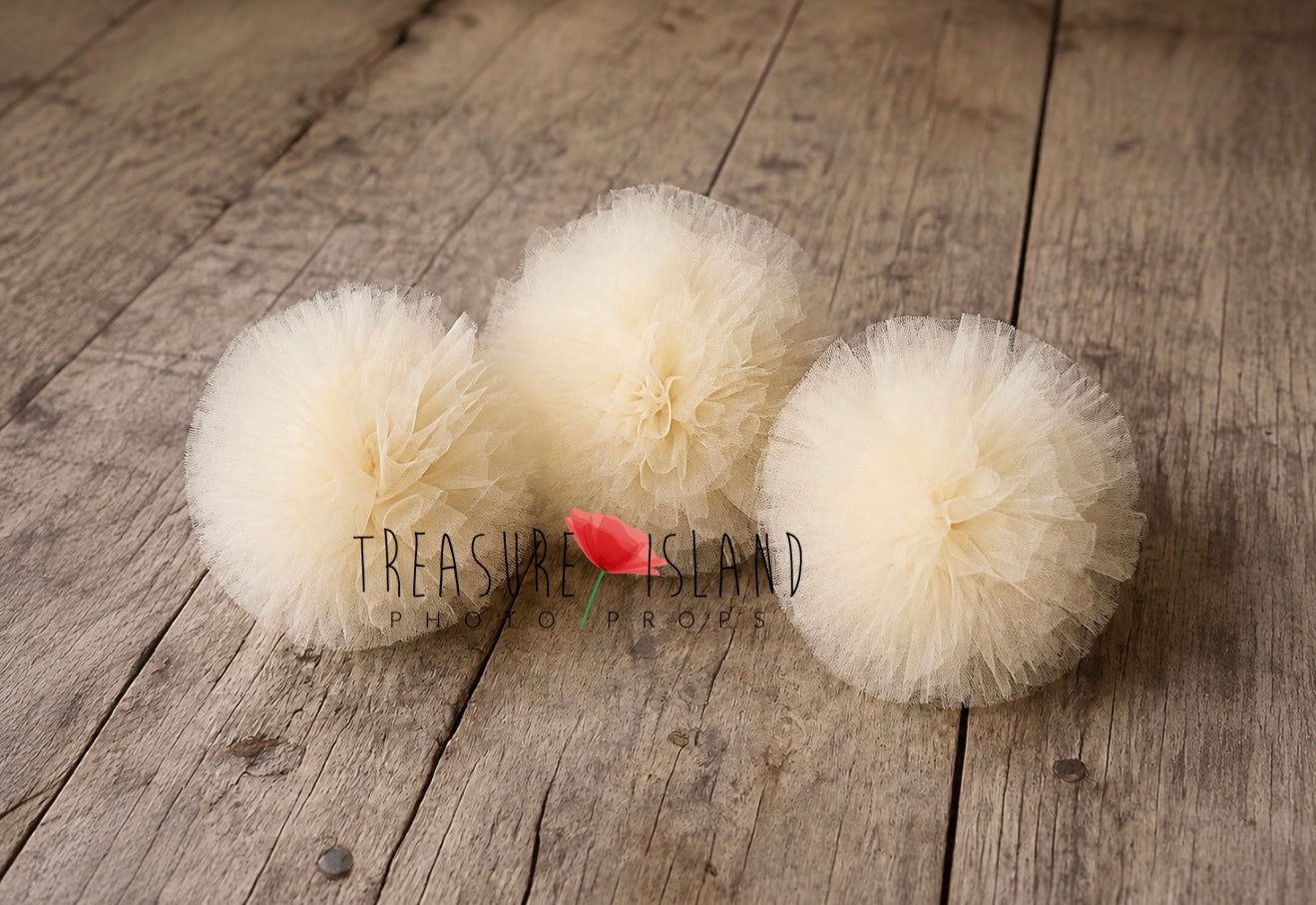 Cream tulle pom poms for photography setups