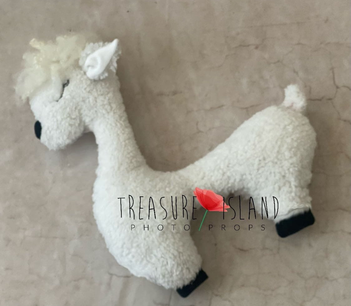A Cream White alpaca posing pillow toy made of fluffy material, designed for photo props, with a logo and red rose in the bottom right corner.