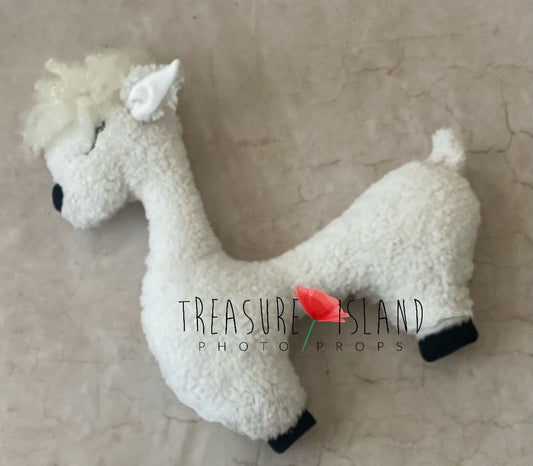 A Cream White alpaca posing pillow toy made of fluffy material, designed for photo props, with a logo and red rose in the bottom right corner.