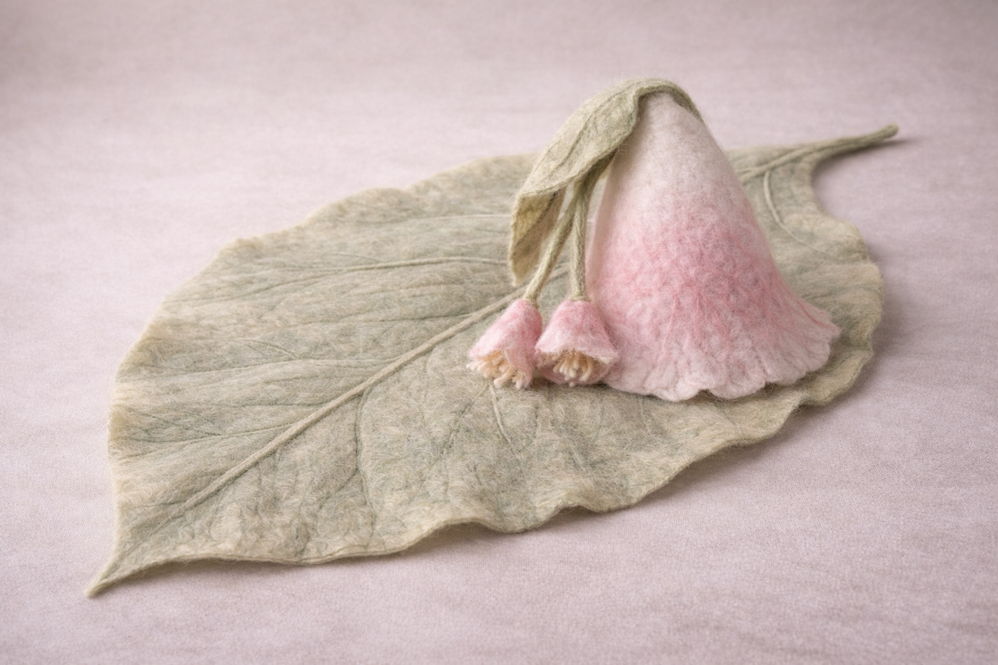 Hand-felted blush flower bonnet with hanging bells and sage leaf blanket, botanical newborn photography set