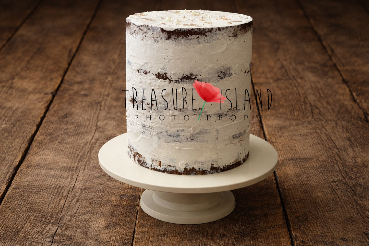 Handcrafted semi-naked white cake prop displayed on a rustic wooden floor, textured frosting with visible layers, neutral newborn cake smash photography setup
