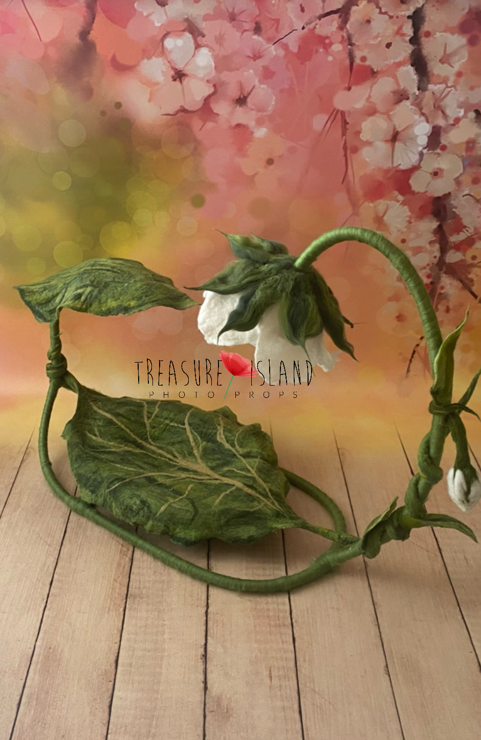 Side view of felted botanical newborn posing hammock with curved flower stem