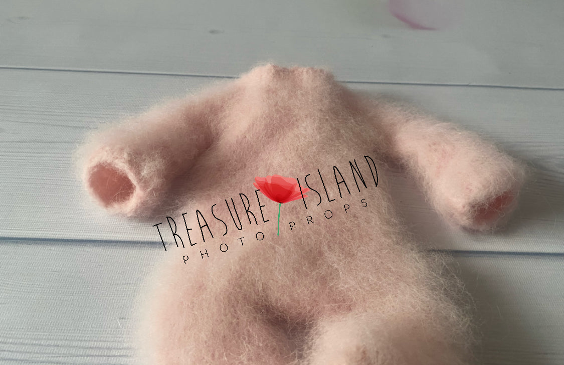Close-up of baby pink fluffy knitted romper showing soft alpaca wool texture