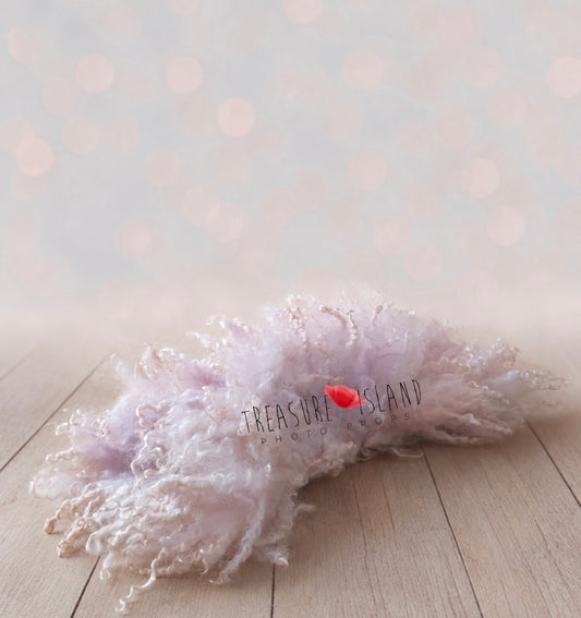 Lilac blush curly wool blanket arranged as a soft newborn photography layer