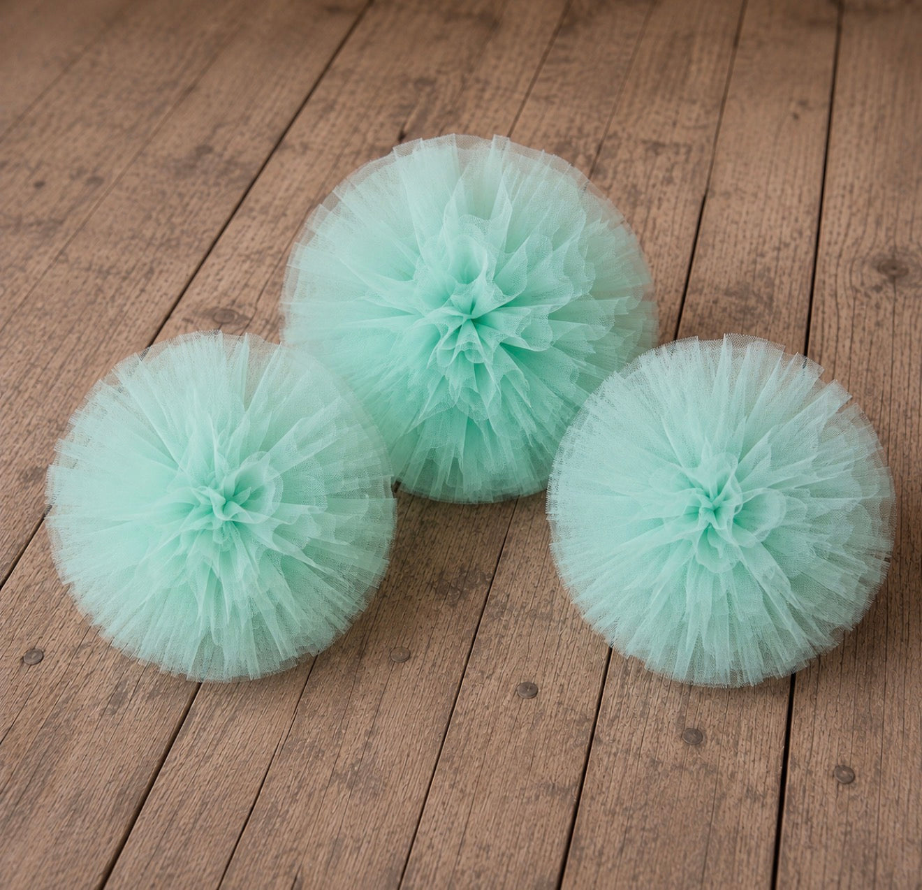 Mint lilac tulle pom poms in multiple sizes for photography setups