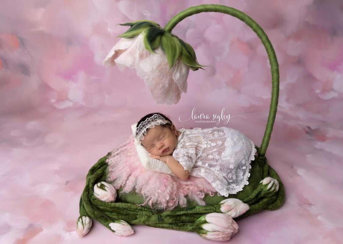 Newborn posed in handmade Thumbelina floral nest with large felted flower