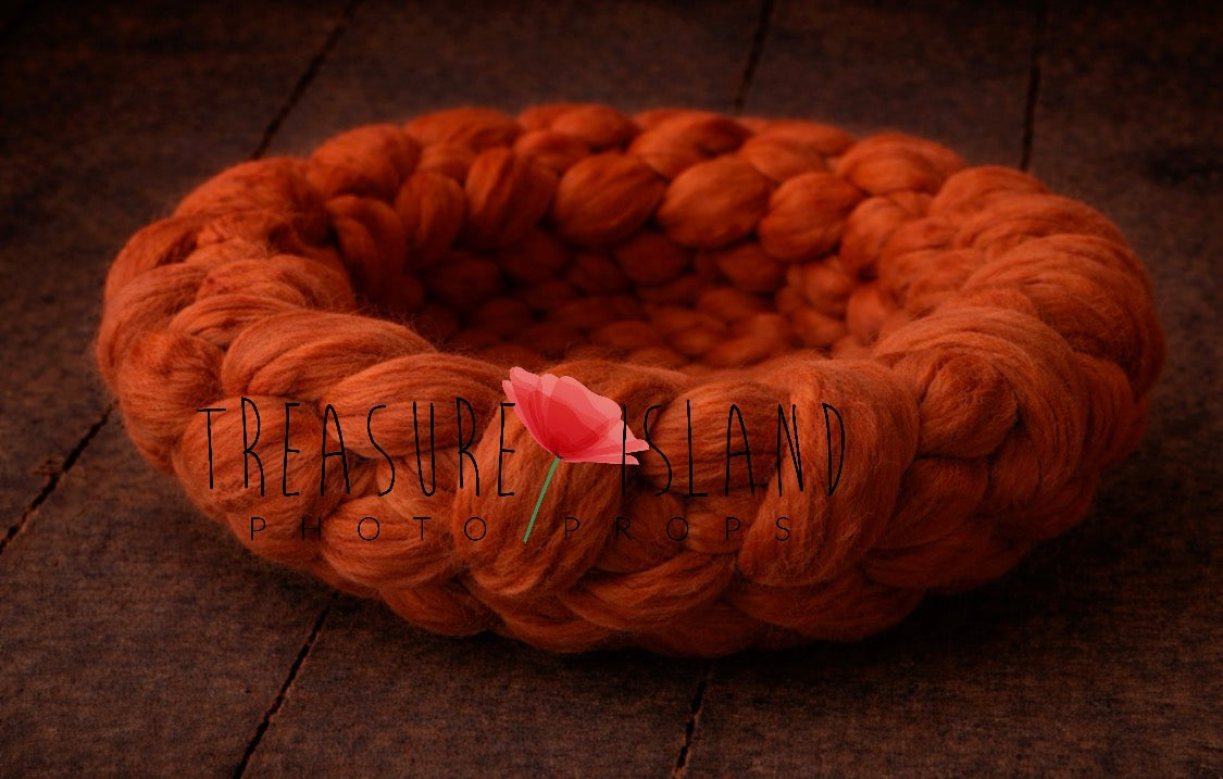 Side view of handmade chunky wool photography nest in Pumpkin.