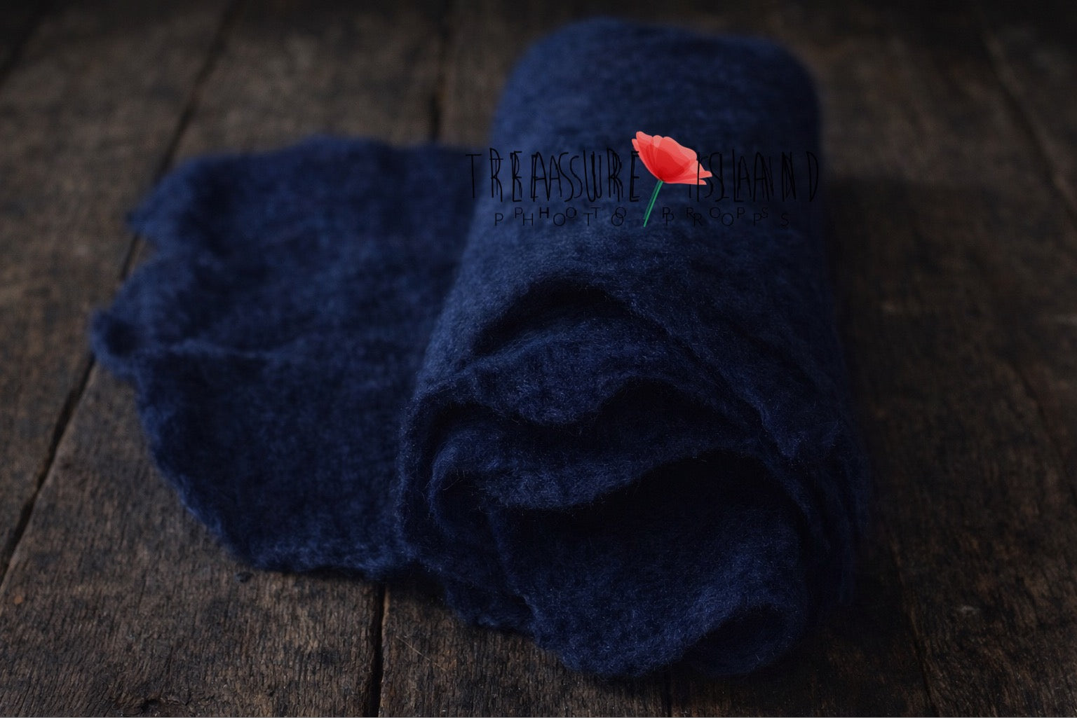 Rolled [colour] hand-felted wool photography blanket showing soft felt texture