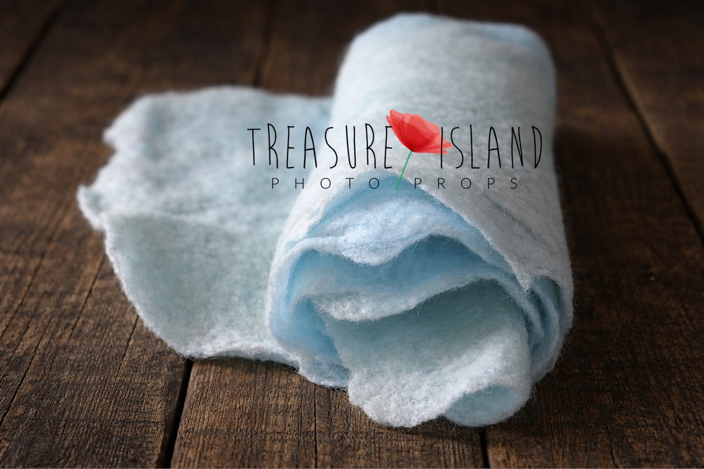 Rolled aqua hand-felted wool photography blanket showing soft felt texture