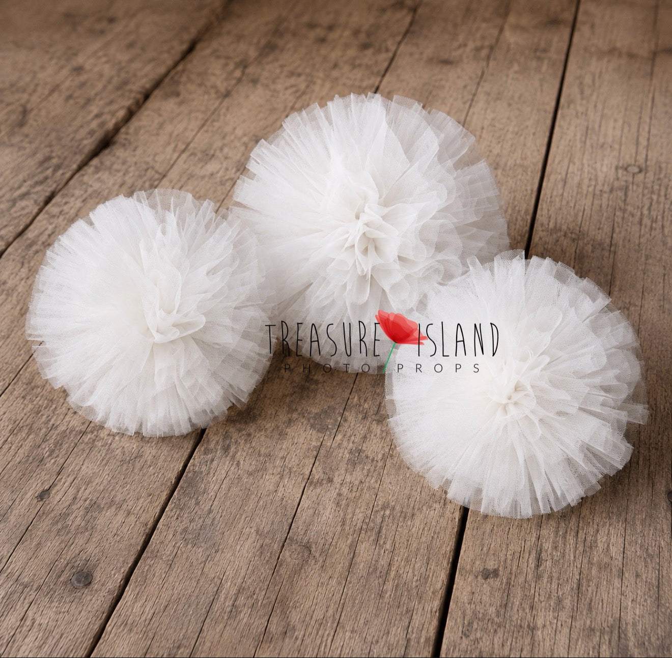 White  tulle pom poms in multiple sizes for photography setups