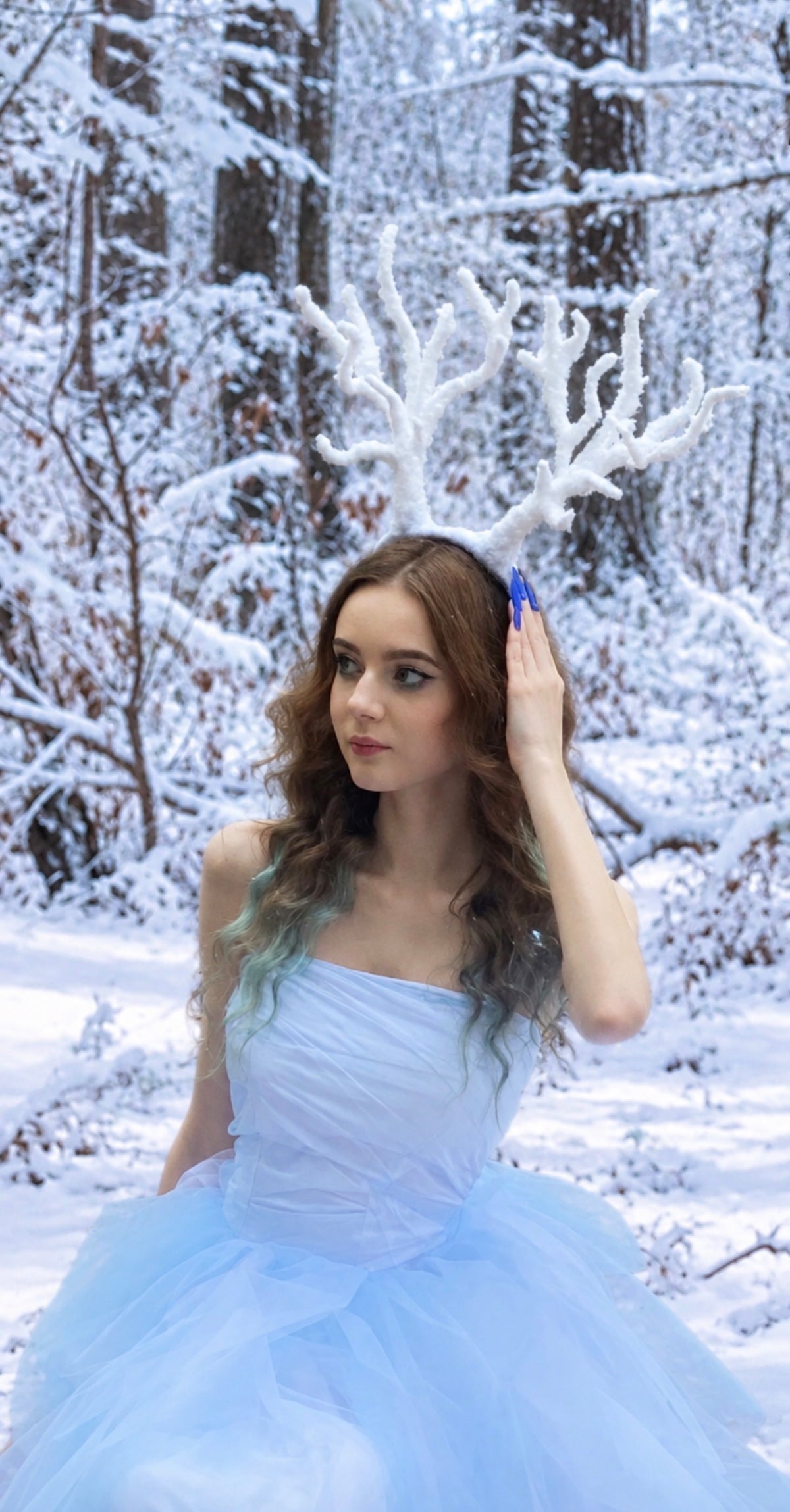 Adult model wearing handmade snowy reindeer antlers headband for winter fine art photography