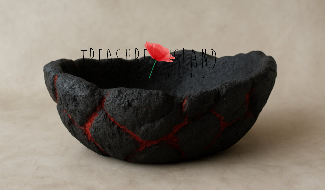 Handmade black volcanic bowl photography prop with red crack details for newborn and sitter sessions