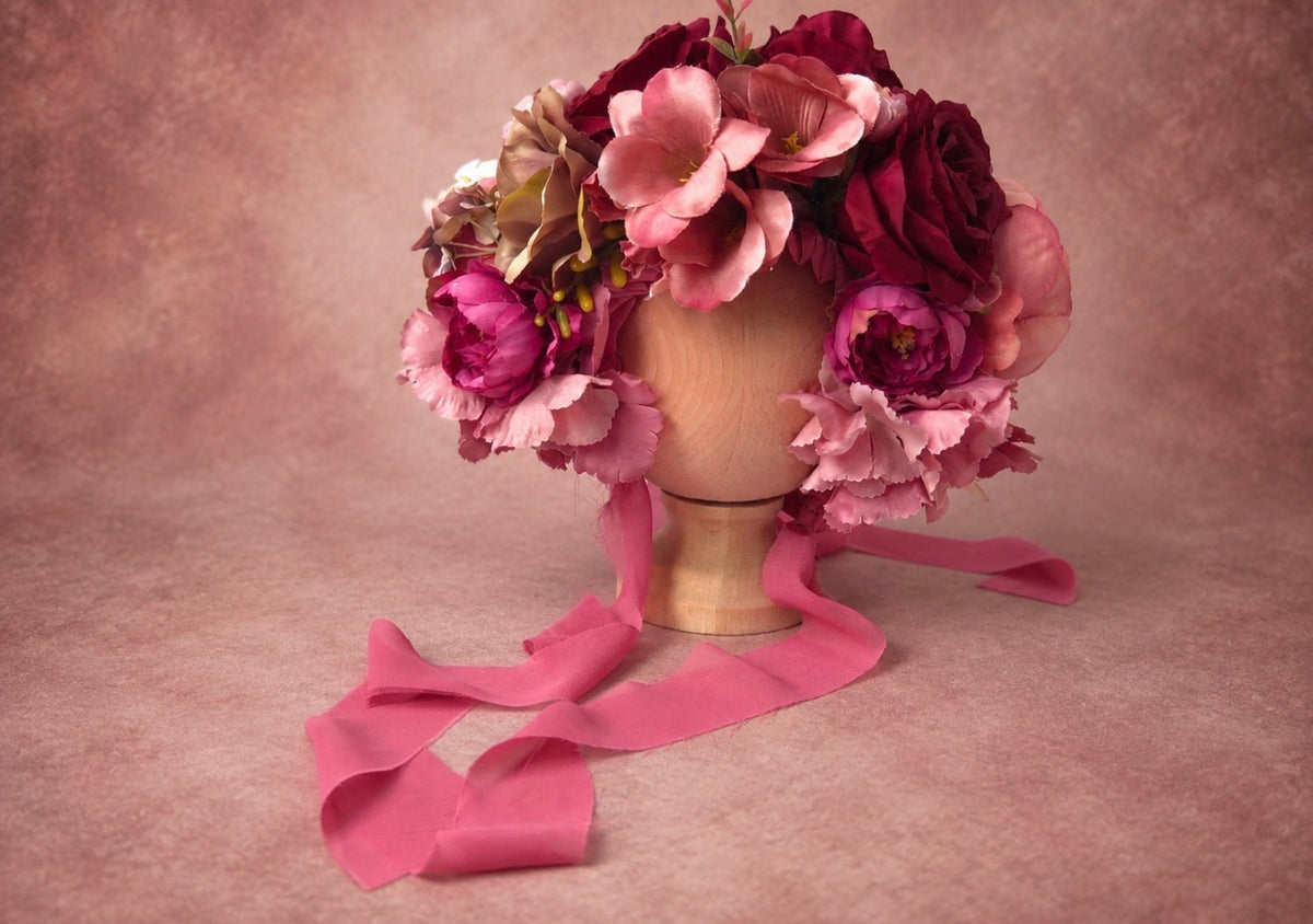 Handmade burgundy floral bonnet with layered roses and long dusty pink ties for fine art photography
