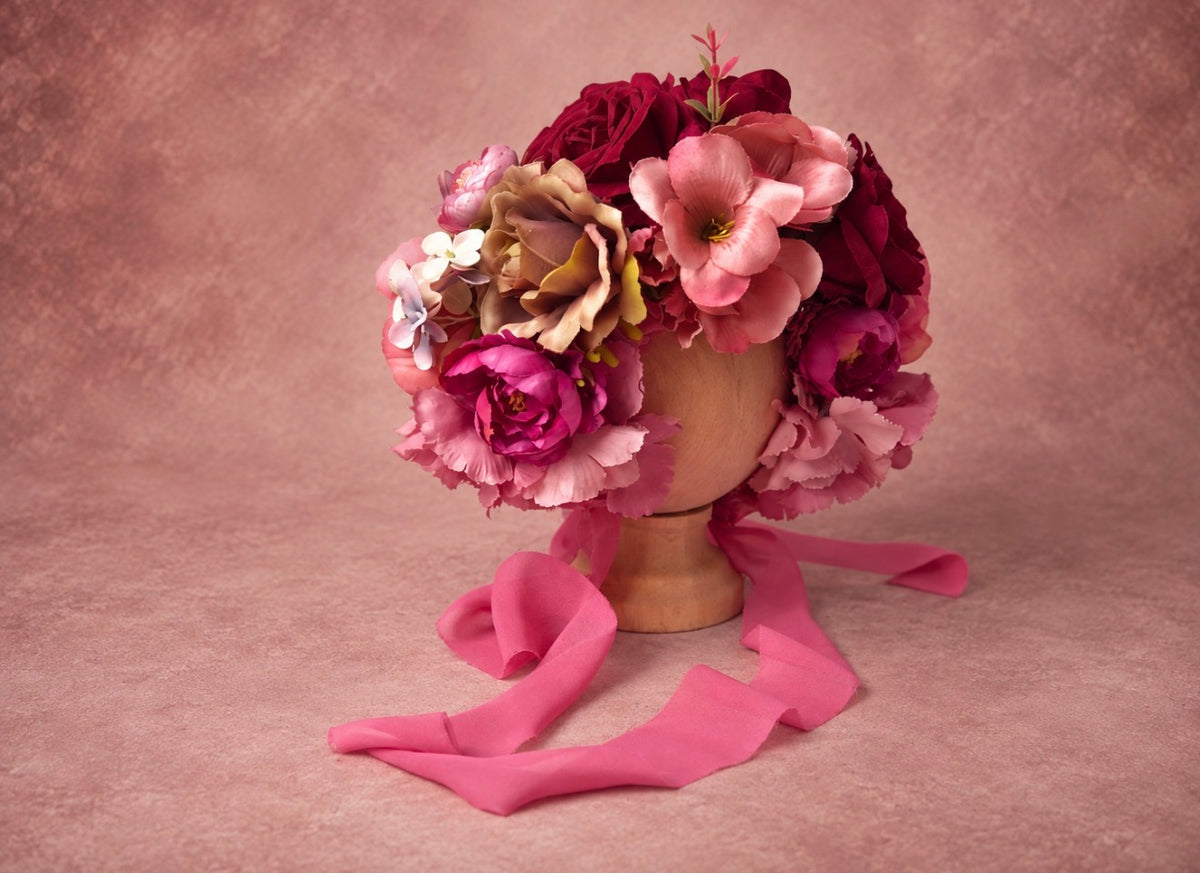 Side view of burgundy rose photography bonnet with raspberry, blush and wine floral arrangement