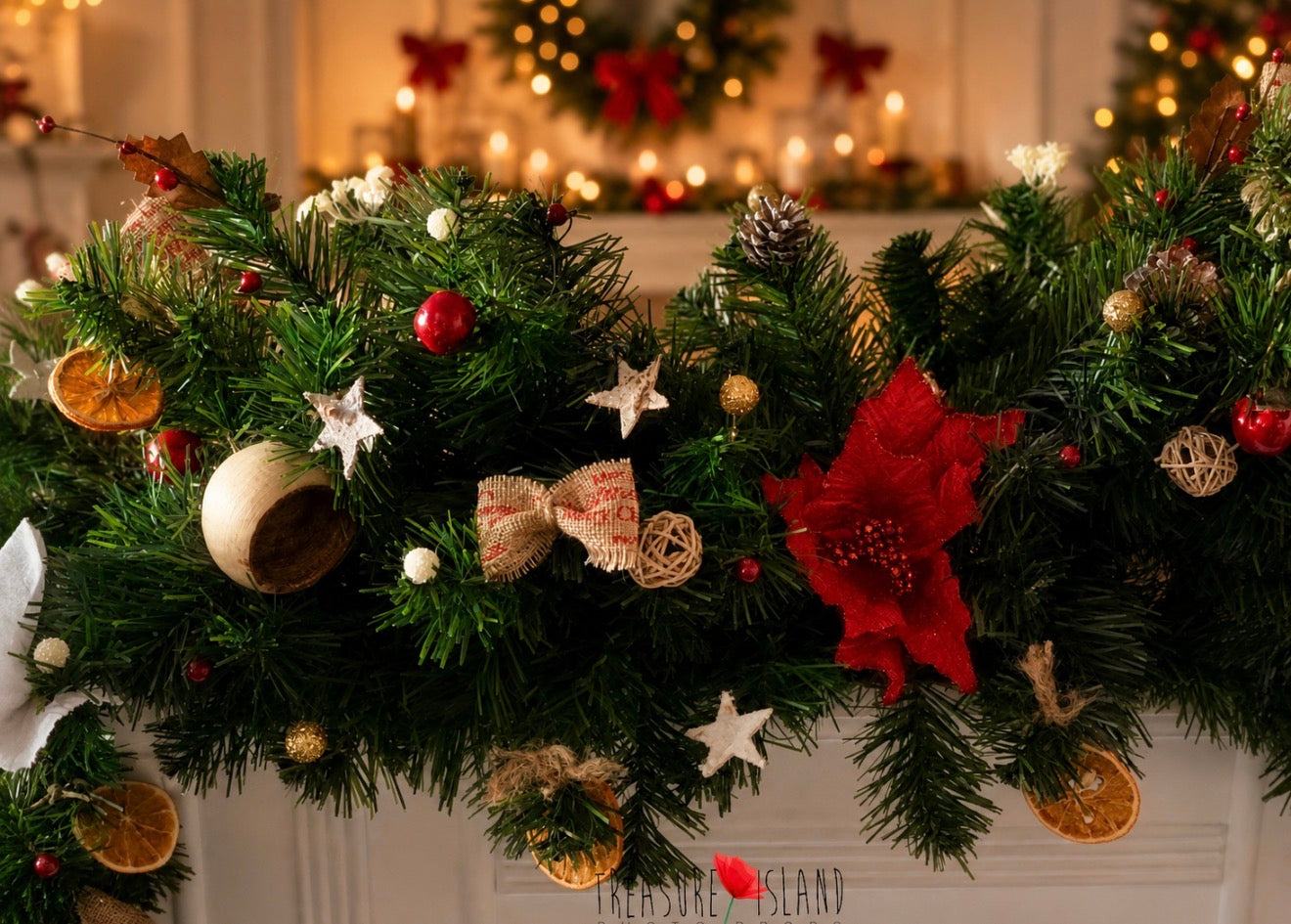 Rich Christmas garland with red poinsettias, rustic bows, dried orange slices and festive details