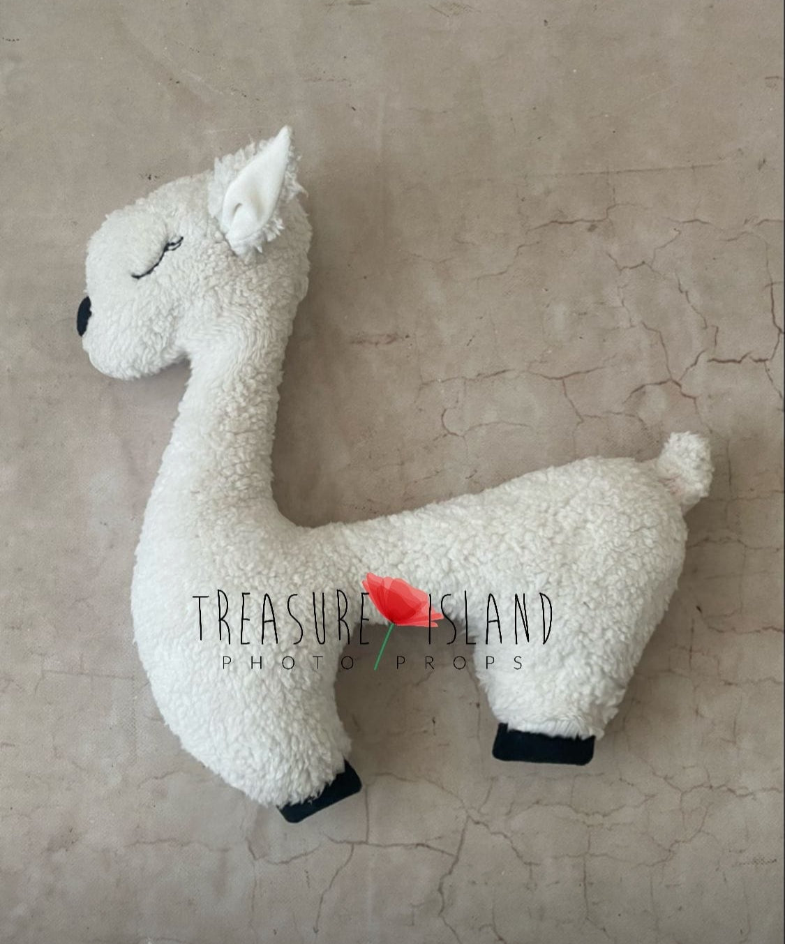 Cream lamb-shaped newborn photography pillow with embroidered eyes and nose