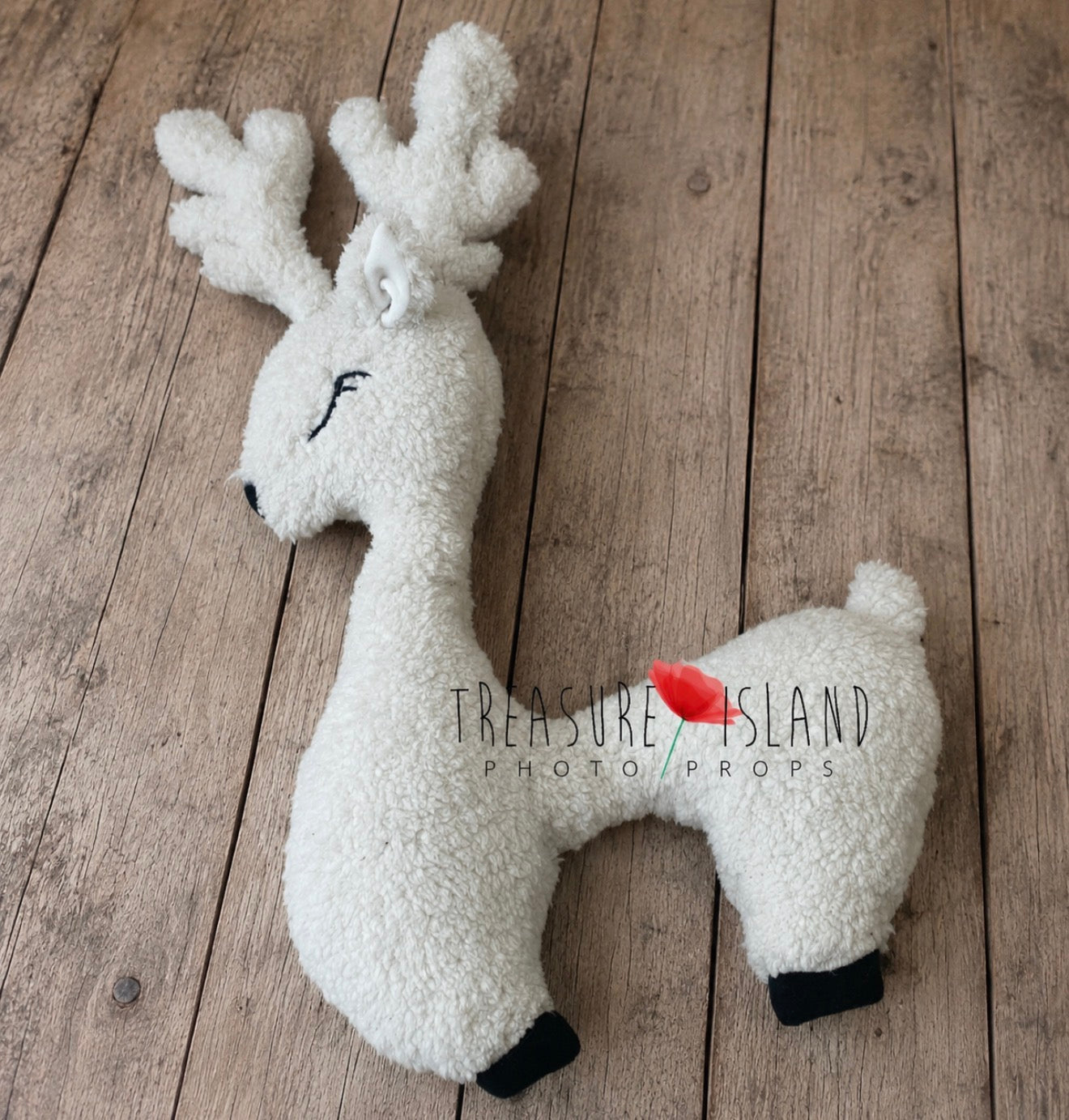 Cream white reindeer newborn posing pillow with embroidered details and soft antlers