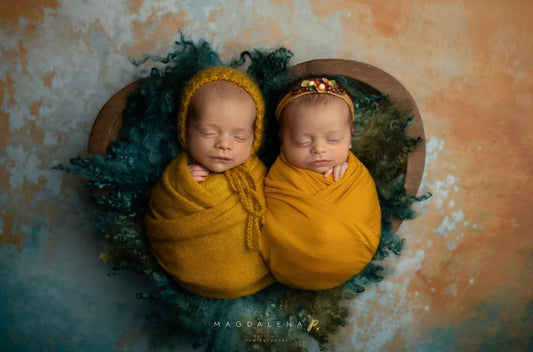 Newborn twins styled with Enchanted Forest curly wool blanket in a woodland photography setup