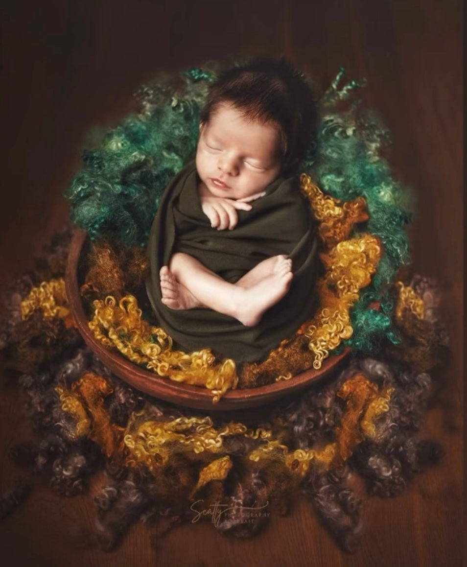 Newborn fine art setup with Enchanted Forest natural sheep curls in green brown and golden tones