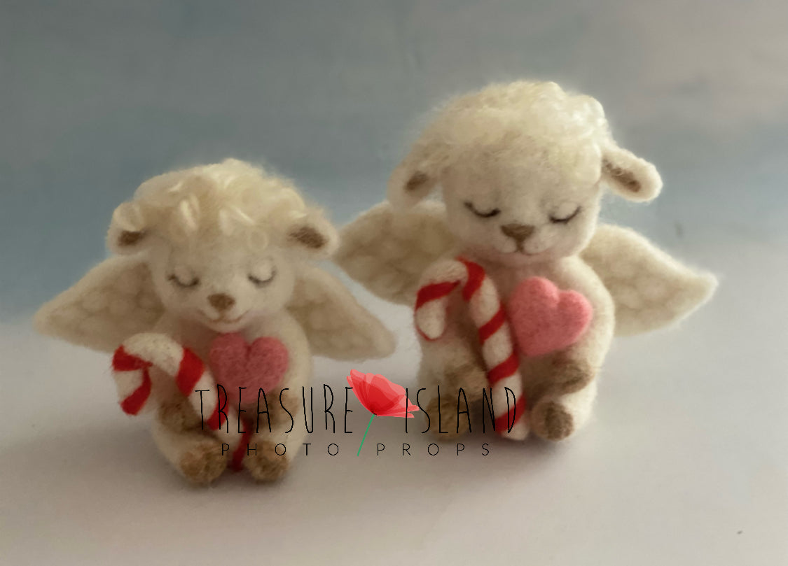 Two handmade felted Christmas sheep angels holding candy canes and pink hearts