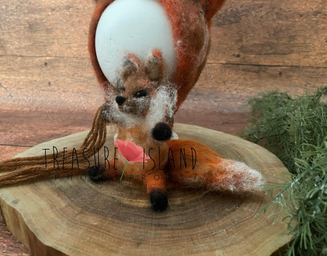 Handmade felted fox bonnet and miniature fox toy styled for woodland newborn photography