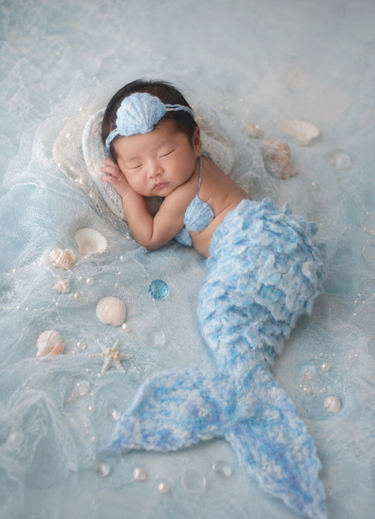 Newborn wearing Ice Pearl handmade felted mermaid tail, shell top and headband