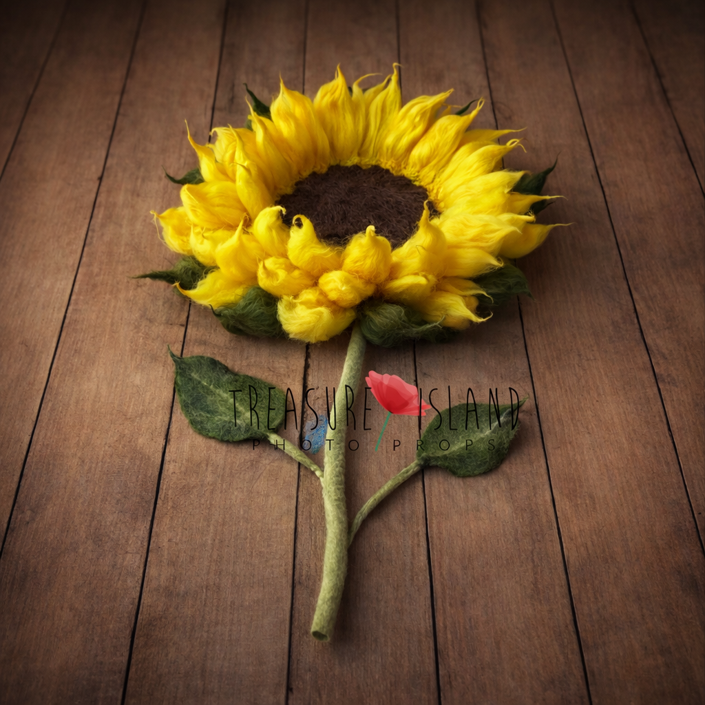 Side view of felted sunflower blanket with handmade stem and leaves