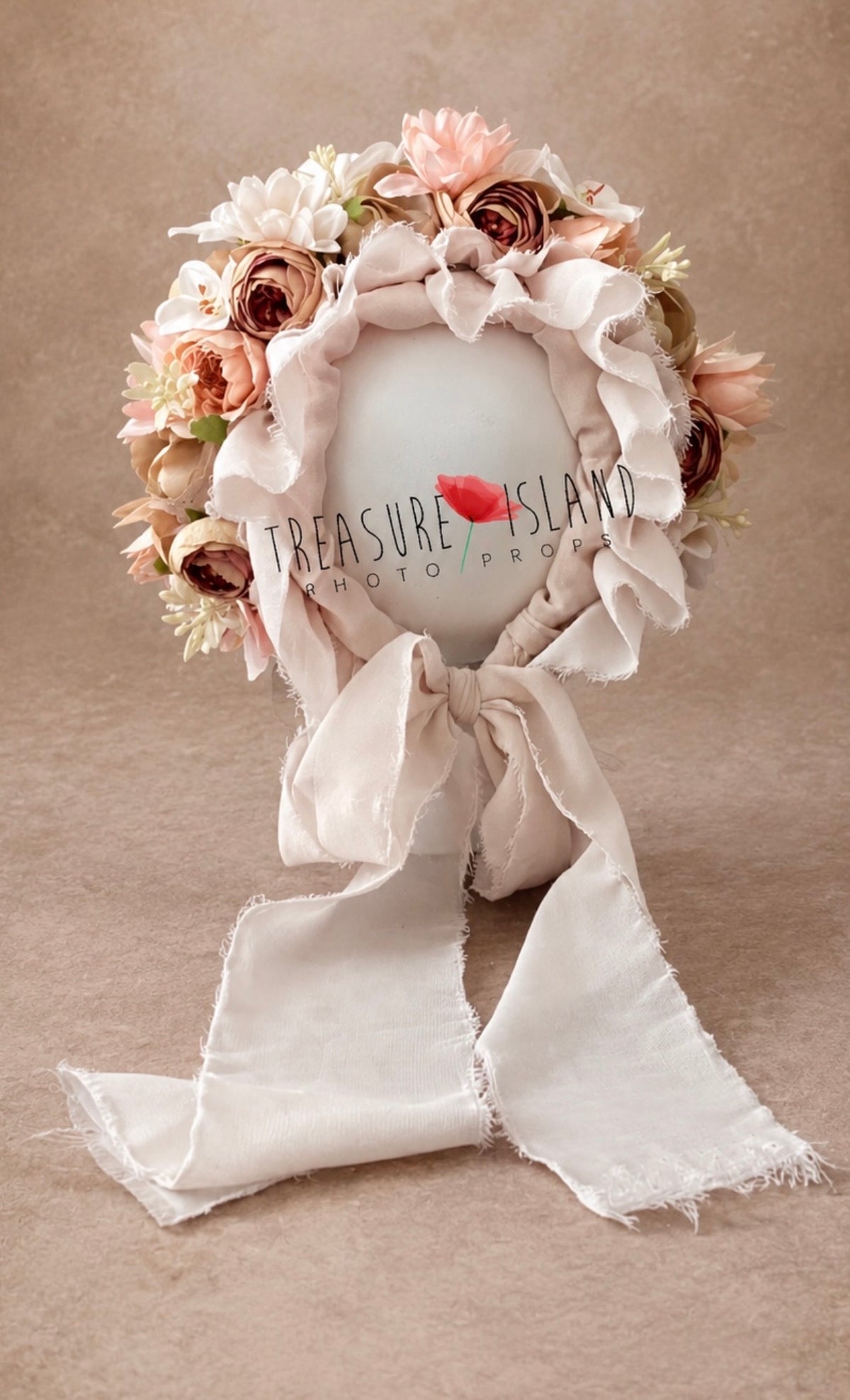 Front view of romantic flower bonnet with soft fabric ruffles and long ties