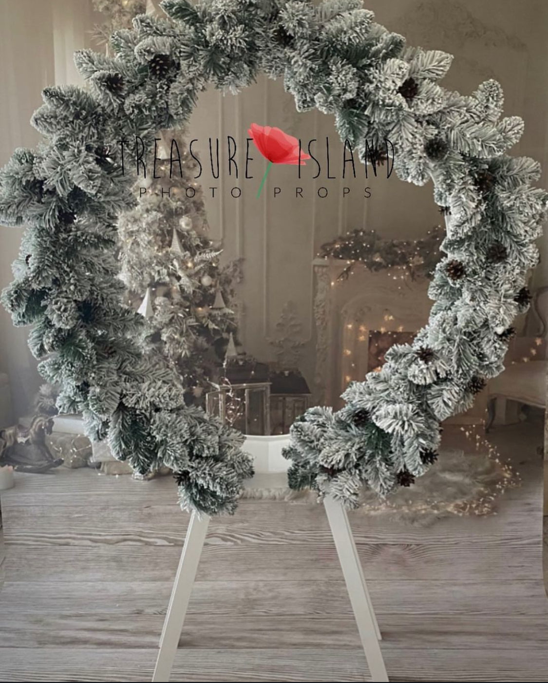 Frosted winter garland with pinecones styled on a round Christmas photography frame