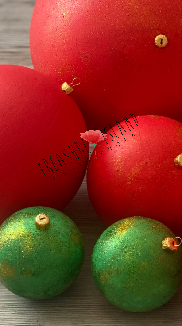 Large red and glitter green Christmas bauble with gold detail for holiday photography setups