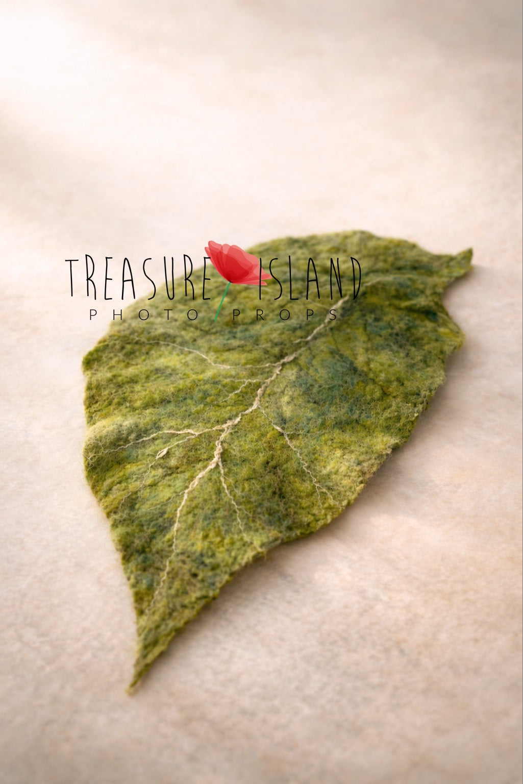 Green hand-felted botanical leaf photography prop with sculpted shape and contrasting veins